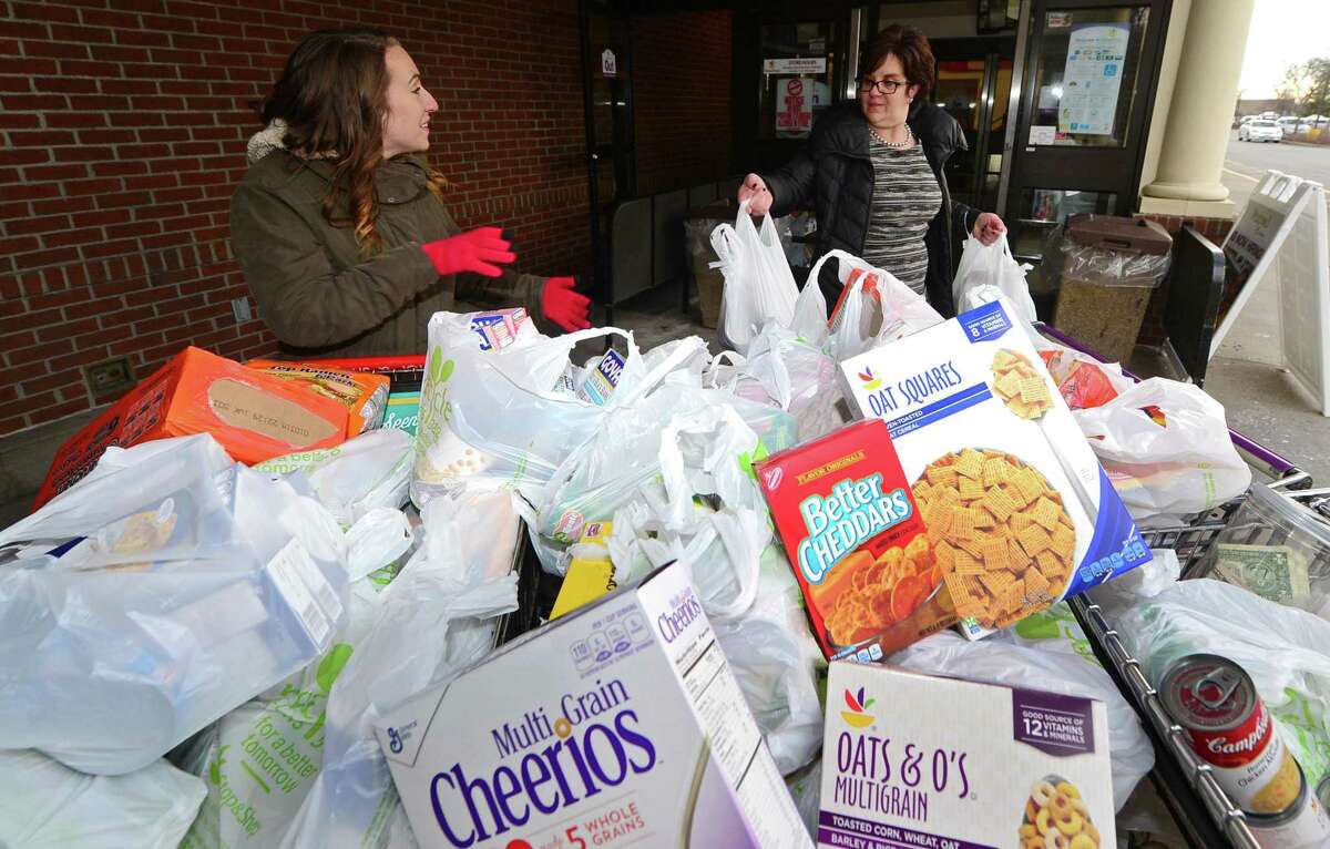 Bridgeport Rescue Missions volunteer coordinator, Courtney Pandolfi accepts donations from Dianne Migliorelli during the Mission's Stuff a Truck food drive Thursday, February 2, 2017, at the Stop & Shop on Main Avenue in Norwalk, Conn. The mission’s “ThanksGiving” food and coat-collection drive will take place November 15-18 and November 20-21 at the Webster Bank Arena from 12:30 to 2 p.m. daily.