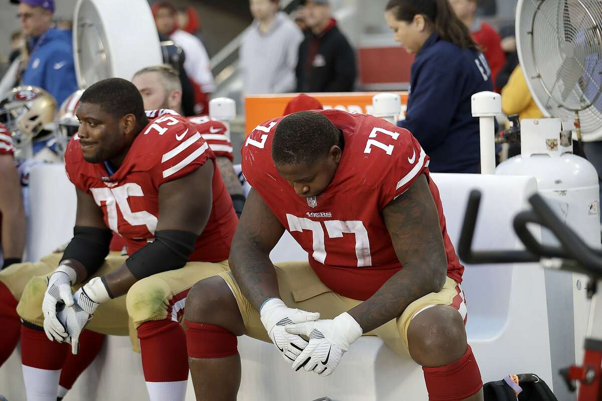 San Francisco 49ers offensive guard Laken Tomlinson (75) and offensive tackle Trent Brown (77) sit on the bench during the second half of an NFL football game against the Arizona Cardinals in Santa Clara on Sunday, Nov. 5, 2017. 