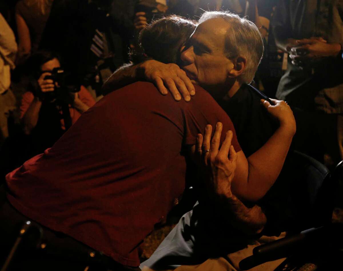 Texas Gov. Greg Abbott hugs Sutherland Springs resident Aleida Mora during a candle light vigil for the shooting at the First Baptist Church of Sutherland Springs Sunday Nov 5, 2017.