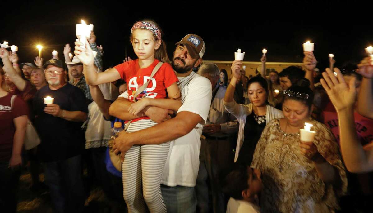 Ramiro Martinez hold his daughter Sophia, 9, during a candle light vigil for the shooting at the First Baptist Church of Sutherland Springs Sunday Nov 5, 2017.