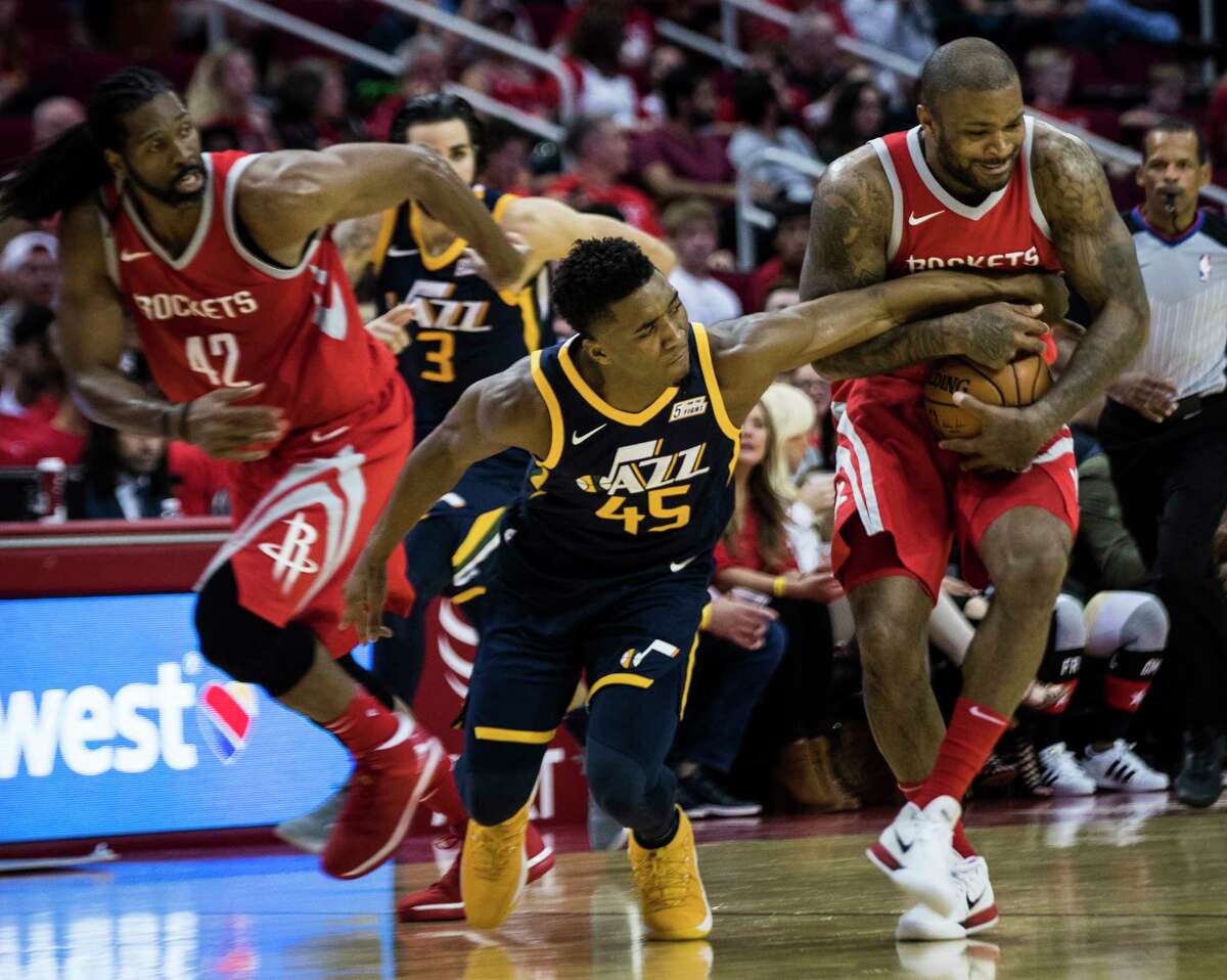 Jazz rookie guard Donovan Mitchell (45) battles for the ball against Rockets forward P.J. Tucker, right, in the second half of Sunday's game at Toyota Center. Tucker played 29 minutes off the bench in the 137-110 win.
