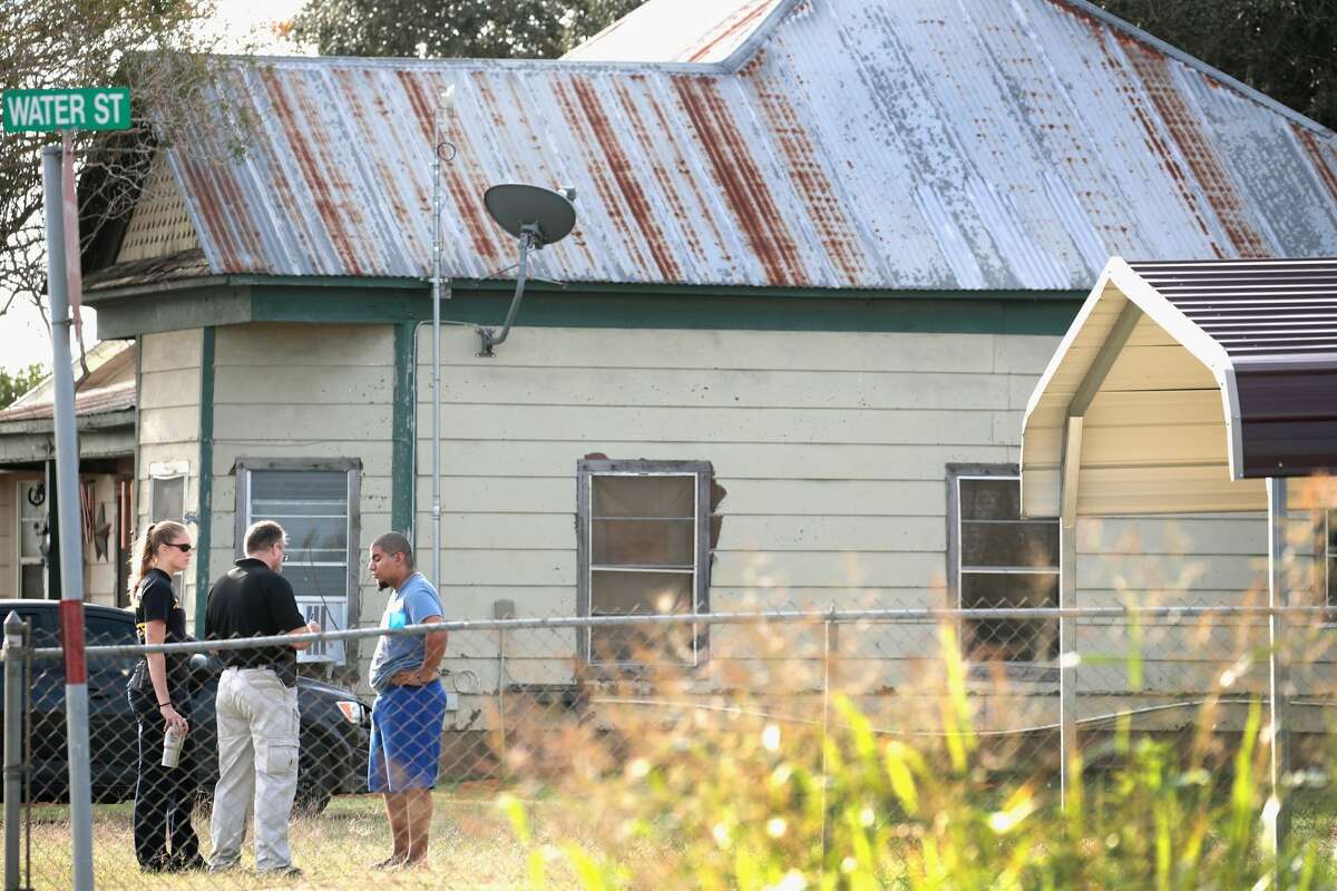 Law enforcement officials interview a resident as they continue their investigation of the shooting at the First Baptist Church of Sutherland Springs on November 6, 2017 in Sutherland Springs, Texas. On November 5 a gunman, Devin Patrick Kelley, killed 26 people at the church and wounded many more when he opened fire during a Sunday service. The cities of San Francisco, New York and Philadelphia filed a sweeping federal lawsuit Tuesday accusing the U.S. Department of Defense of failing to live up to its legal duty to notify the FBI when a member of the military is convicted of a crime that would bar them from buying or possessing firearms.