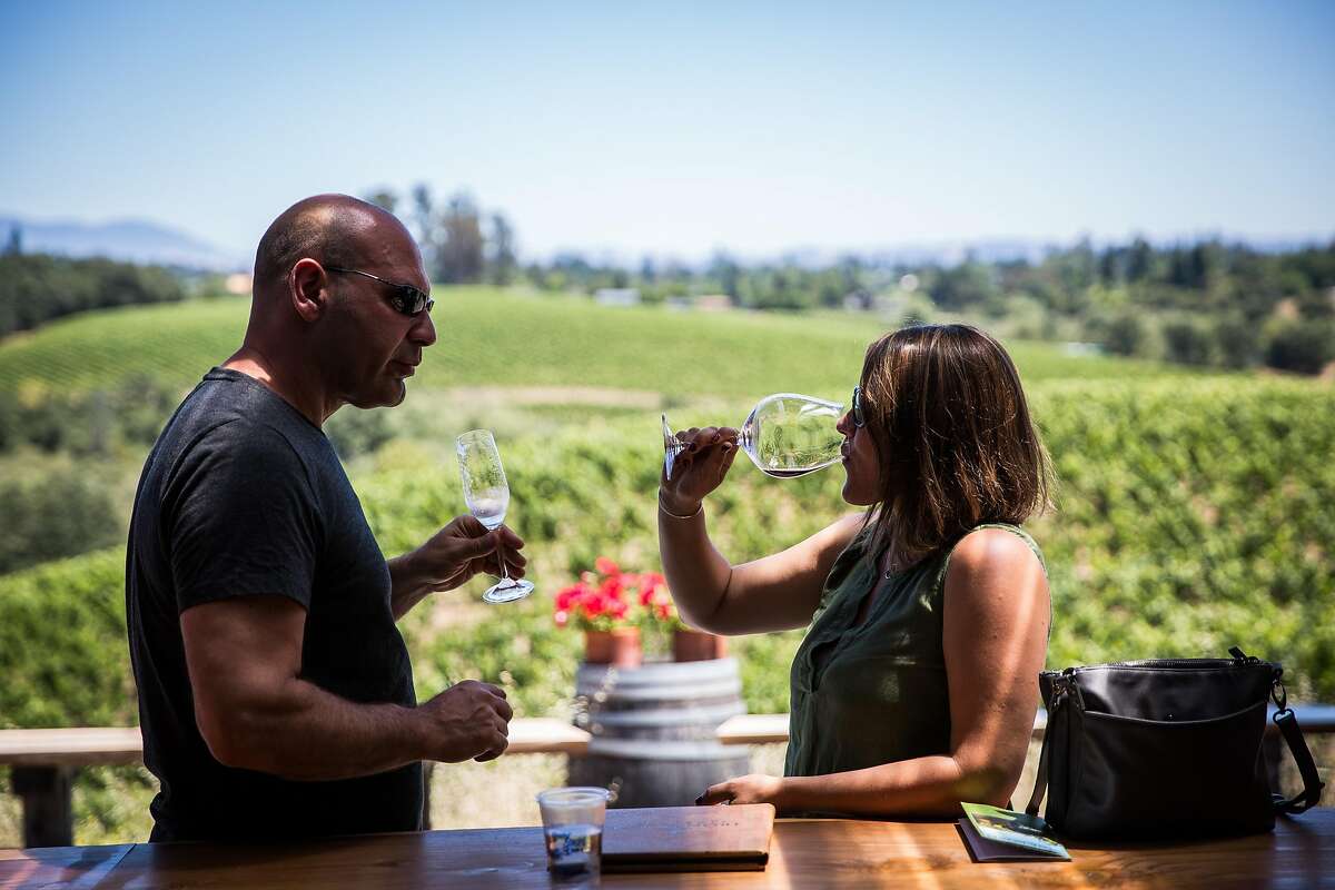 Anthony Palmieri, left, and Kristyn Bogli, both of Boston taste wine at Iron Horse Vineyards in Sebastopol, California on July 6, 2017.