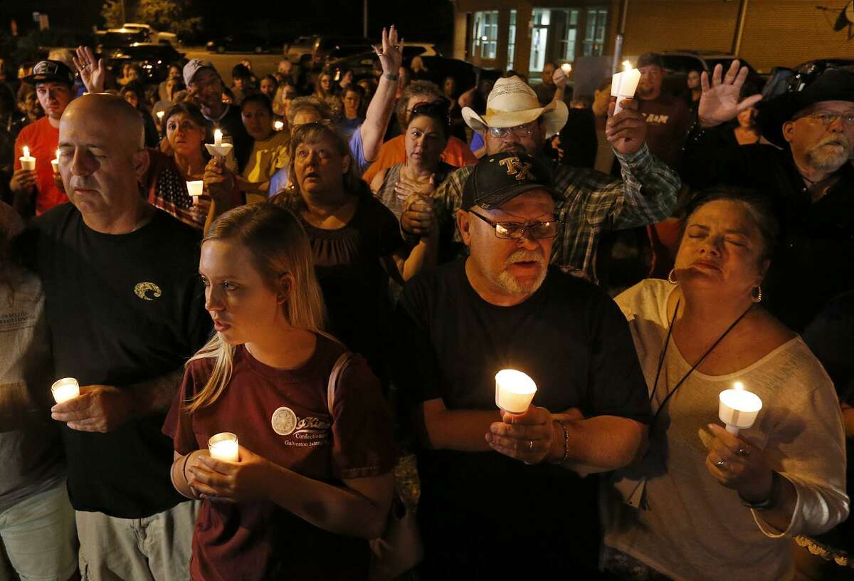 People attend a candle light vigil for the shooting at the First Baptist Church of Sutherland Springs Sunday Nov 5, 2017.