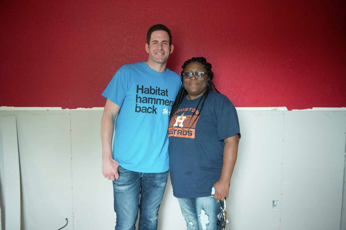 Tarek El Moussa (left) and Zipporah Smith (right) who's home was flooded during Hurricane Harvey gets repairs for her home from Habitat for Humanity Friday November 3, 2017.