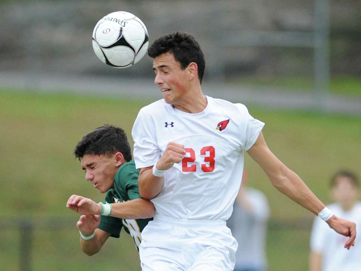 Hamden’s Michael Lanouette II, left, and Greenwich’s Martin Garcia rise up for a header their Class LL state tournament game Monday at Greenwich High School. The Cardinals won 2-0.
