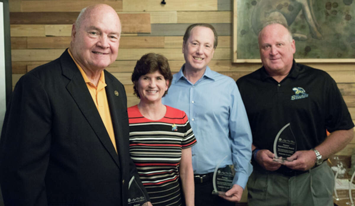 Hope For Three Executive Director Darla Farmer, honors, from left, Robert Hebert, Fort Bend County judge; Jim McClellan, president of the Fred & Mabel R. Parks Foundation, and Jay Miller, president, Sugar Land Skeeters, with Partner Appreciation Awards for their long-term support.