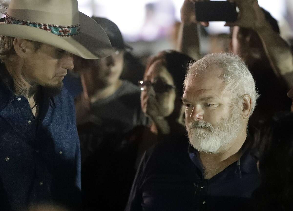 Stephen Willeford, right and Johnnie Langendorff, left, attend a vigil for the victims of the First Baptist Church shooting Monday, Nov. 6, 2017, in Sutherland Springs, Texas. Willeford shot suspect Devin Patrick Kelley, and Langendorff drove the truck while chasing Kelley. Kelley had opened fire inside the church in the small South Texas community on Sunday, killing more than two dozen and injuring others. (AP Photo/David J. Phillip)