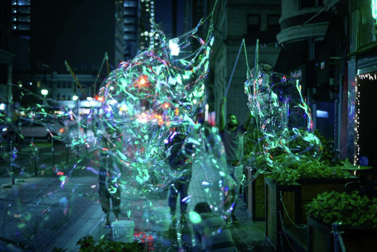 The collaborative CRITT Project will perform "Burst," a piece involving dance and massive bubbles, on a grassy slope near Market Street as part of the 2017 edition of Luminaria.