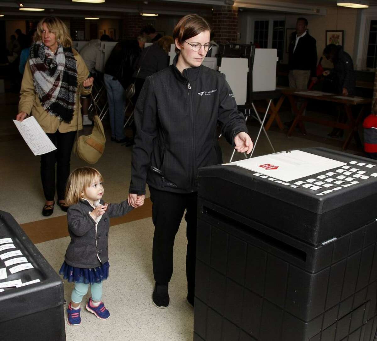Kim Pont and daughter, Winter, age 2, vote at Clinton Town Hall Tuesday.