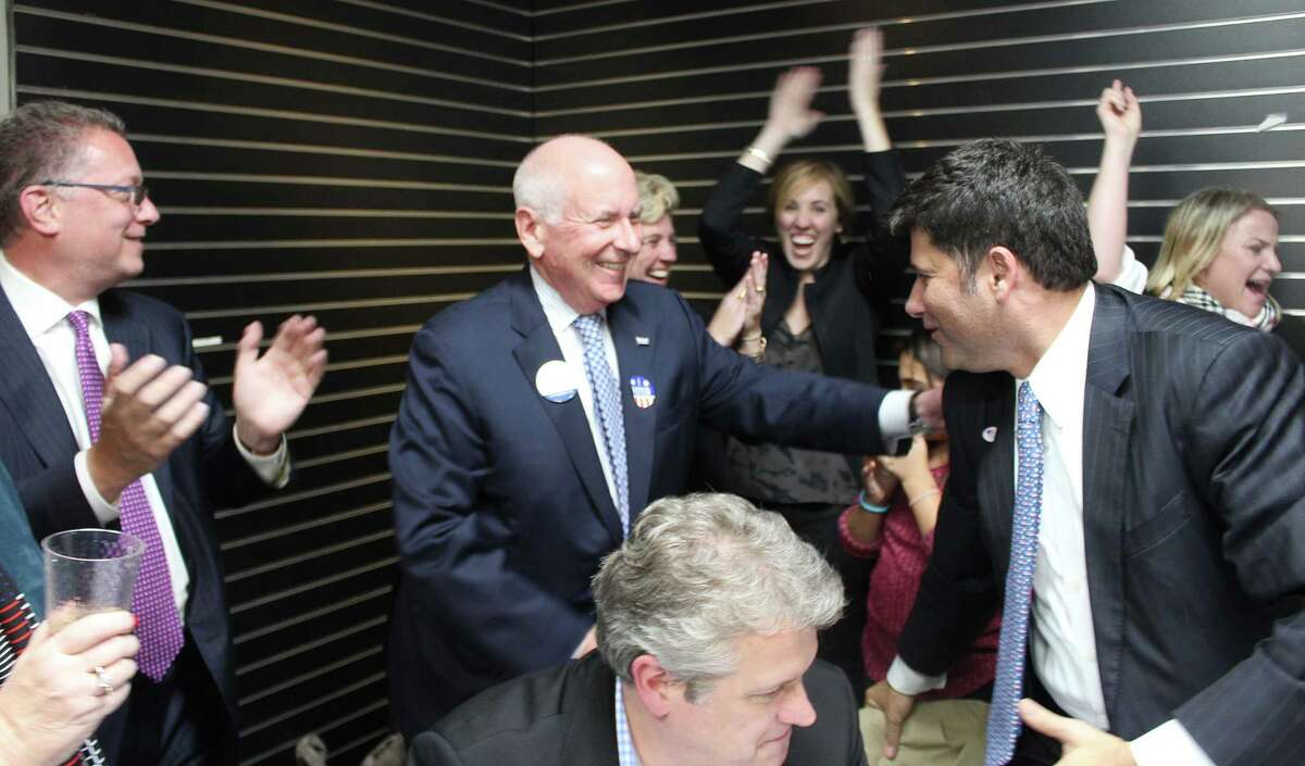 First Selectman Jim Marpe, center, celebrates winning re-election at the Republican Town Committee headquarters at 170 Post Road West.
