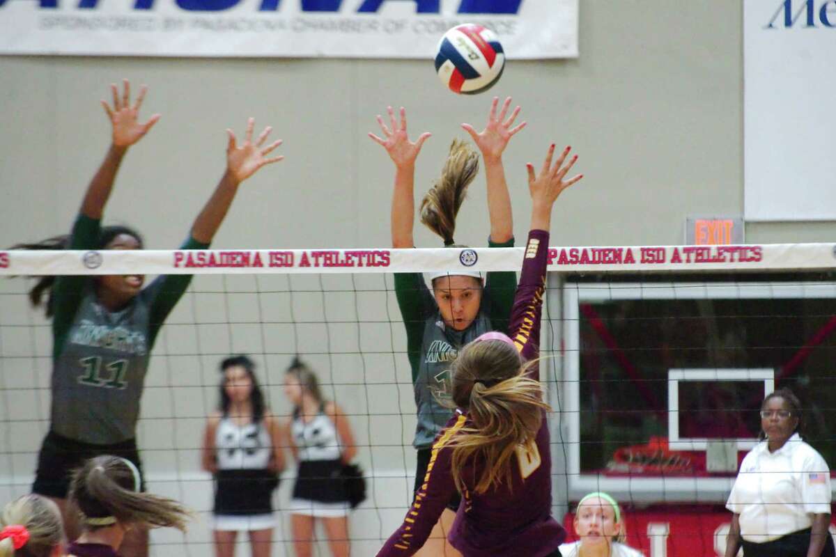 Clear Falls' Rachel Brown (11) and Clear Falls' Briana Garcia (12) go high to block a shot by Deer Park's Courtney Plocheck (6) Tuesday, Nov. 7 at Pasadena ISD Phillips Field House.