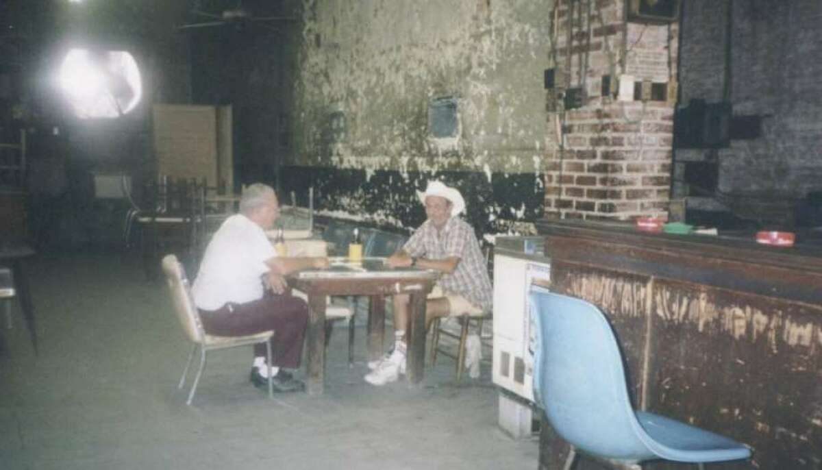 Gentlemen play dominos at Talley's Domino Hall in downtown Conroe in 1999.