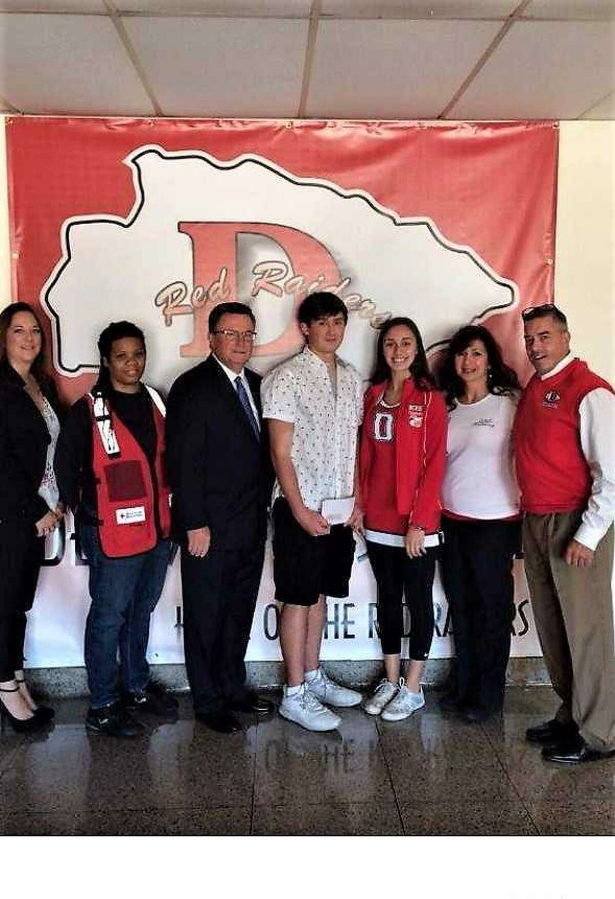 From left, Teri Pough, of CironeFriedberg, LLP, Sharon Escoffery, Red Cross volunteer, William H. VanAlstyne, of CironeFriedberg, LLP, DHS student Chase Boulton, DHS student Victoria Ramirez, Maria Bellone-Lajeunesse, owner of Maria's Hair Gallery and Derby Superintendent of Schools Matthew Conway