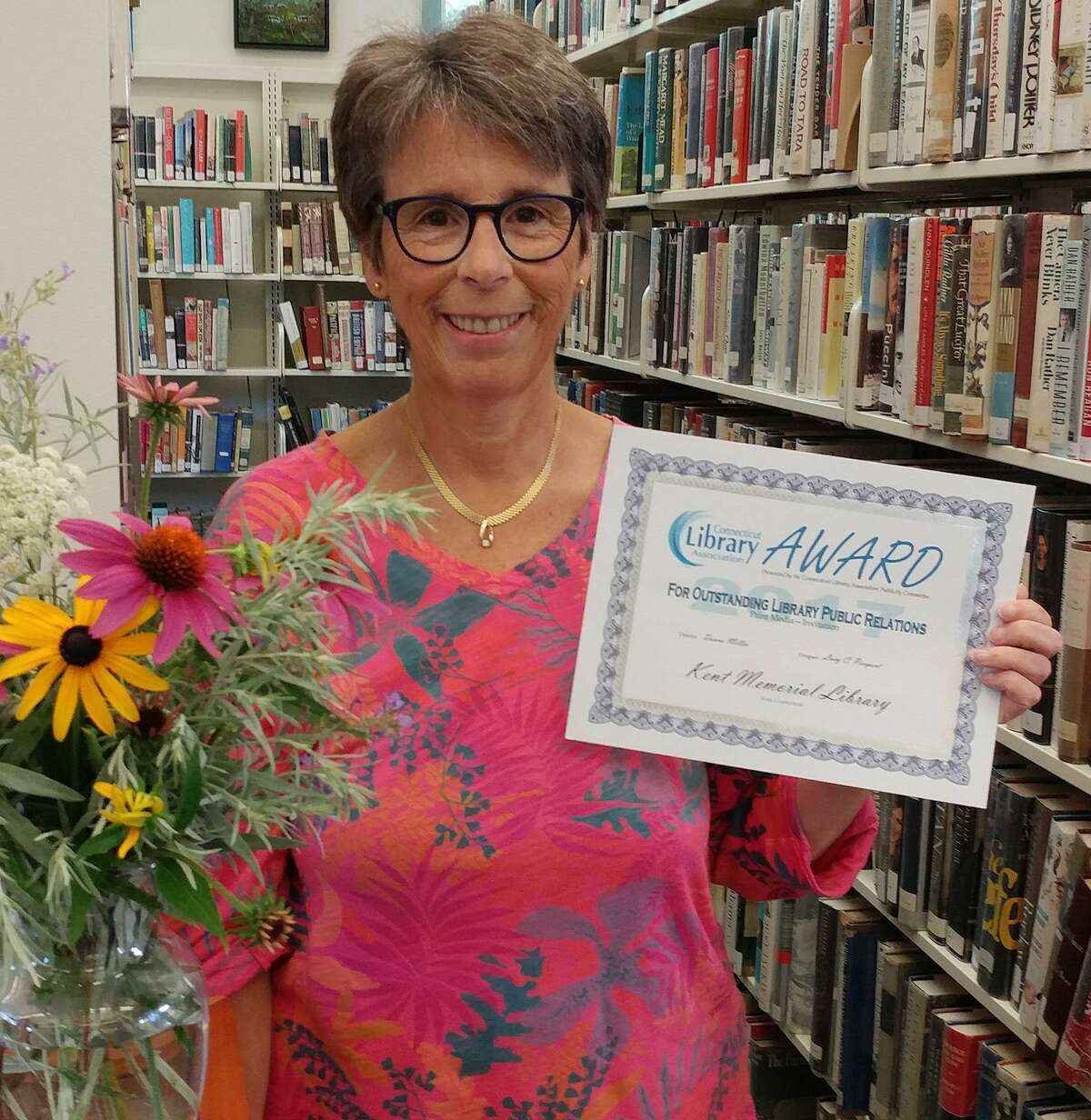 Kent Memorial Library’s Marketing and Special Events Director Lucy C. Pierpont holds the award won for Outstanding Library Public Relations in Print Media for the invitation and program materials for the 2016 Annual Spring Gala fundraising event in Kent.