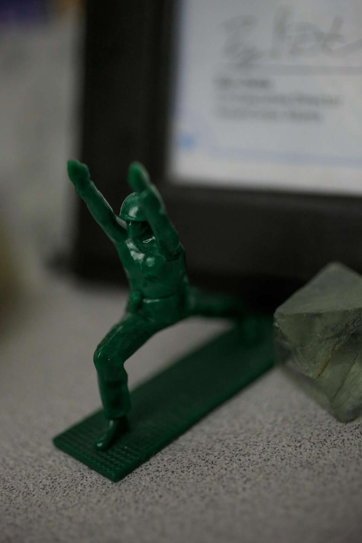 A "yoga joe" army statue sits on Kevin Miller's desk at Swords to Plowshares in San Francisco, Calif., on Monday, Nov. 6, 2017. Kevin Miller is a patient of the VA hospital and a veteran with post traumatic stress disorder, a traumatic brain injury and an injury in his neck from an accident while on tour.