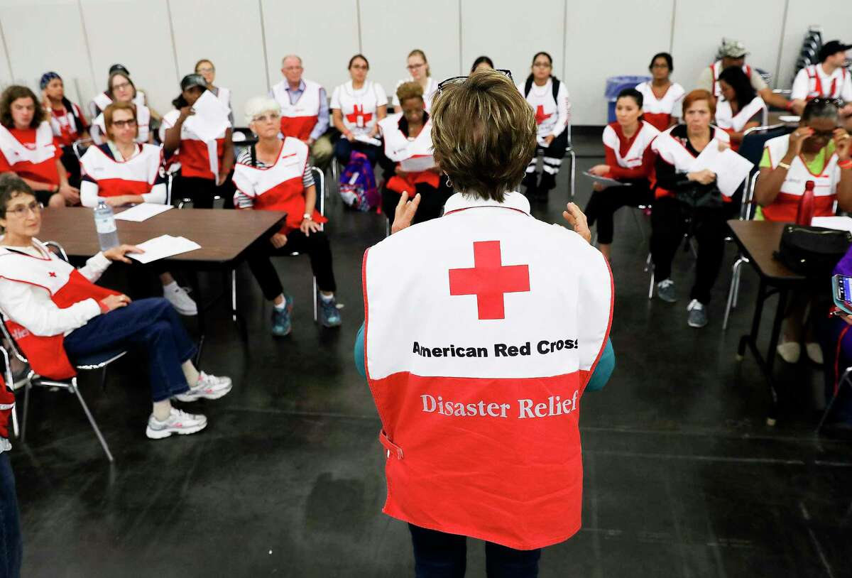 Red Cross manager Sue Engler instructs volunteers at the George R. Brown Convention Center on Sunday, Sept. 10, 2017, in Houston. ( Elizabeth Conley / Houston Chronicle )