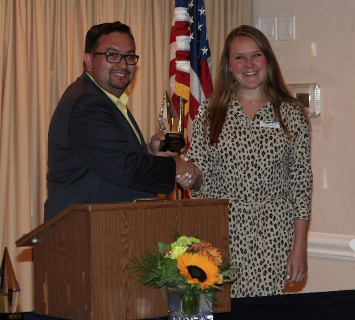The Midland Hispanic Chamber of Commerce on Oct. 31 named Rogers Ford corporation of the year at the chamber's annual meeting. MHCC board member Eddie Montoya, left, presented Claire Nelson, Rogers Ford advertising and internet sales manager, the award.