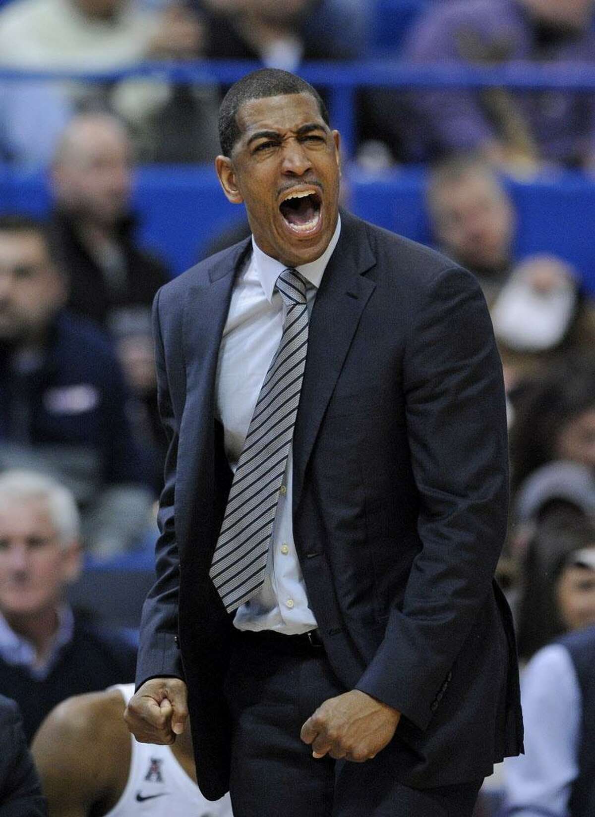 UConn coach Kevin Ollie reacts during overtime of a Dec. 23 game against Auburn. Though the Huskies finished 16-17 last season, observers don’t feel his job is in jeopardy just yet.