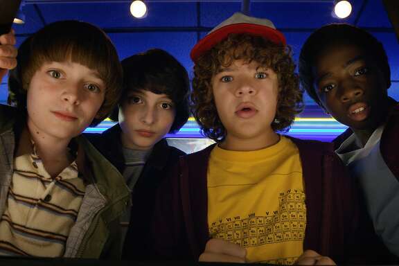 This image released by Netflix shows Noah Schnapp, from left, Finn Wolfhard, Gaten Matarazzo and Caleb Mclaughlin in a scene from "Stranger Things," premiering its second season on Friday. (Netflix via AP)