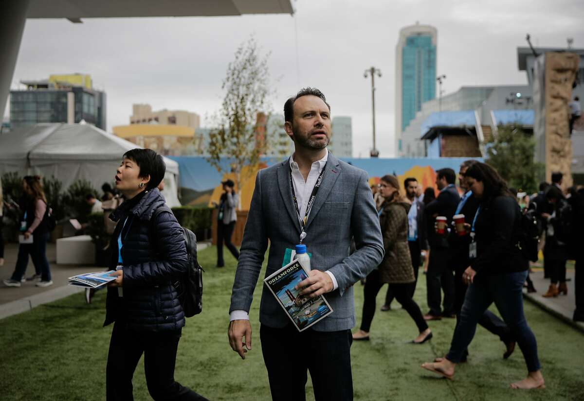 The chair of the dreamforce event Michael Peachey (center) pauses for a moment before entering the Moscone center south in San Francisco, Calif., on Wednesday, Nov. 8, 2017.