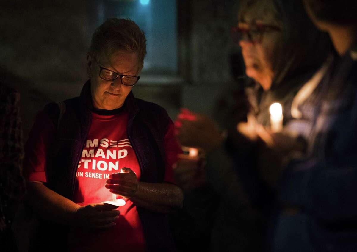 Cat Yuracka (left) holds a candle during a vigil against gun violence Wednesday at Madison Square Presbyterian Church. The vigil was hosted by the San Antonio branch of of “Moms Demand Action for Gun Sense in America,” a movement patterned after Mothers Against Drunk Driving.
