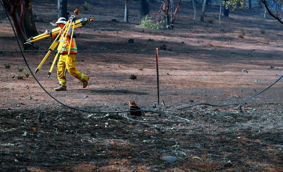 A partially burned power line on the ground as investigators searched for the cause of the Atlas fire east of Santa Rosa, Ca. as seen on Tuesday October 17, 2017.
