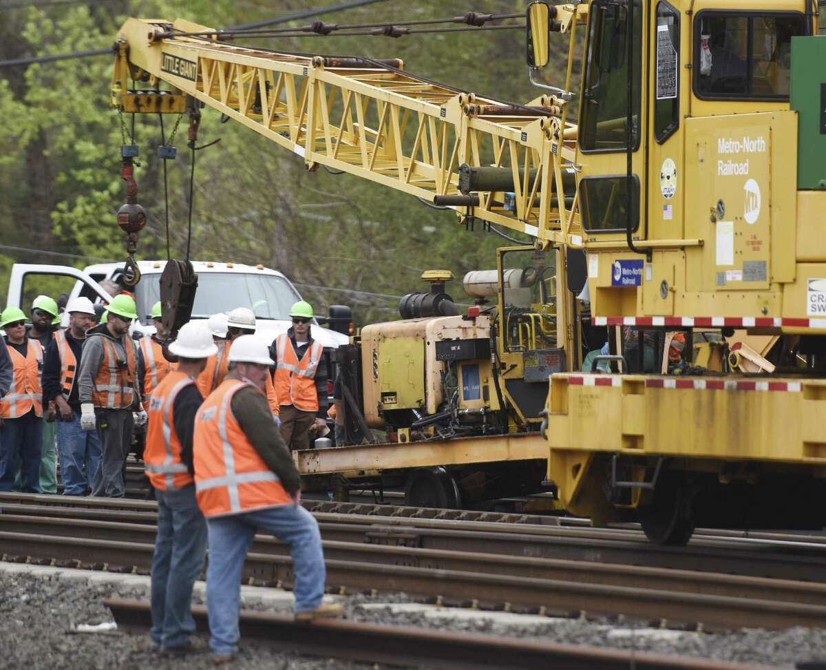 MTA employees gather after a piece of construction equipment derailed between in Greenwich, Conn. on May 5, 2016, resulting in a minor injury to one worker.