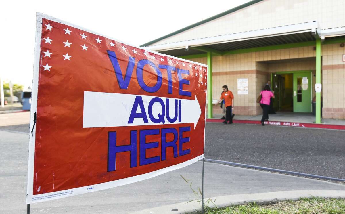 Voters enter and exit the Don Jose Gallegos Elementary voting site on Thursday, Nov. 7, 2017.