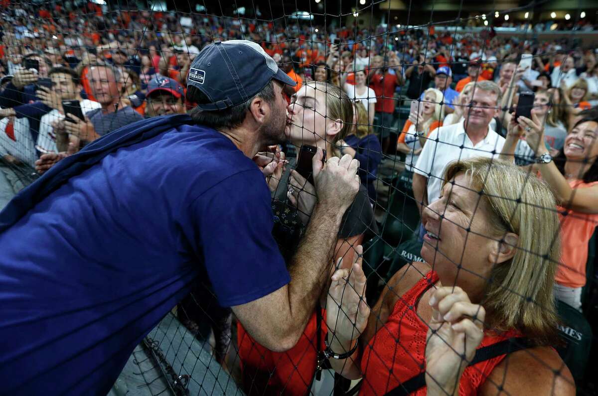 Houston Astros starting pitcher Justin Verlander kisses his fiance, Kate Upton, through the nettting as he and the rest of the team celebrate with the fans by running around the perimeter of the field after they clinched the American League West crown after beating the Seattle Mariners 7-1 during an MLB baseball game at Minute Maid Park, Sunday, Sept. 17, 2017, in Houston. ( Karen Warren / Houston Chronicle )