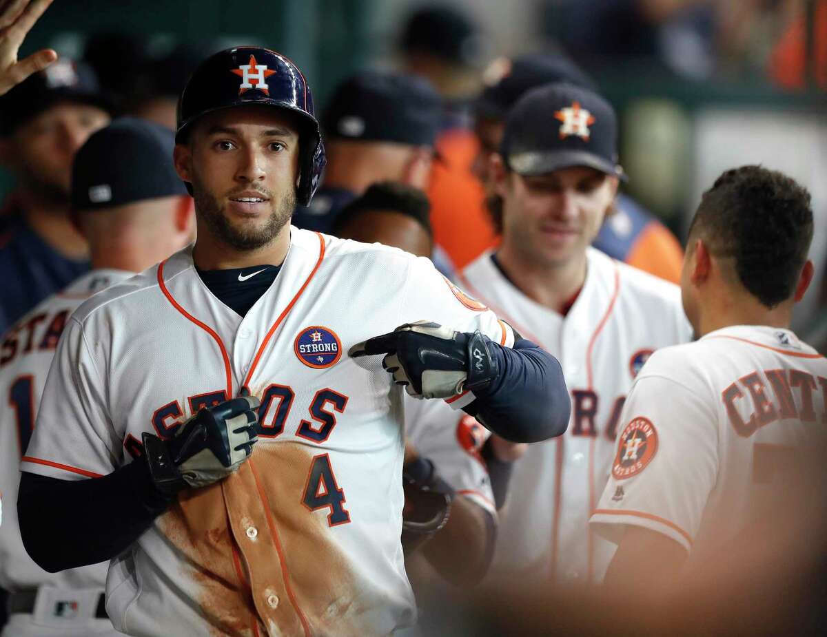 Houston Astros George Springer (4) points to his "Houston Strong" patch after hitting a two-run home run in the second inning of an MLB baseball game at Minute Maid Park, Saturday, Sept. 2, 2017, in Houston. This is the first professional sporting event in the city since Tropical Storm Harvey. ( Karen Warren / Houston Chronicle )