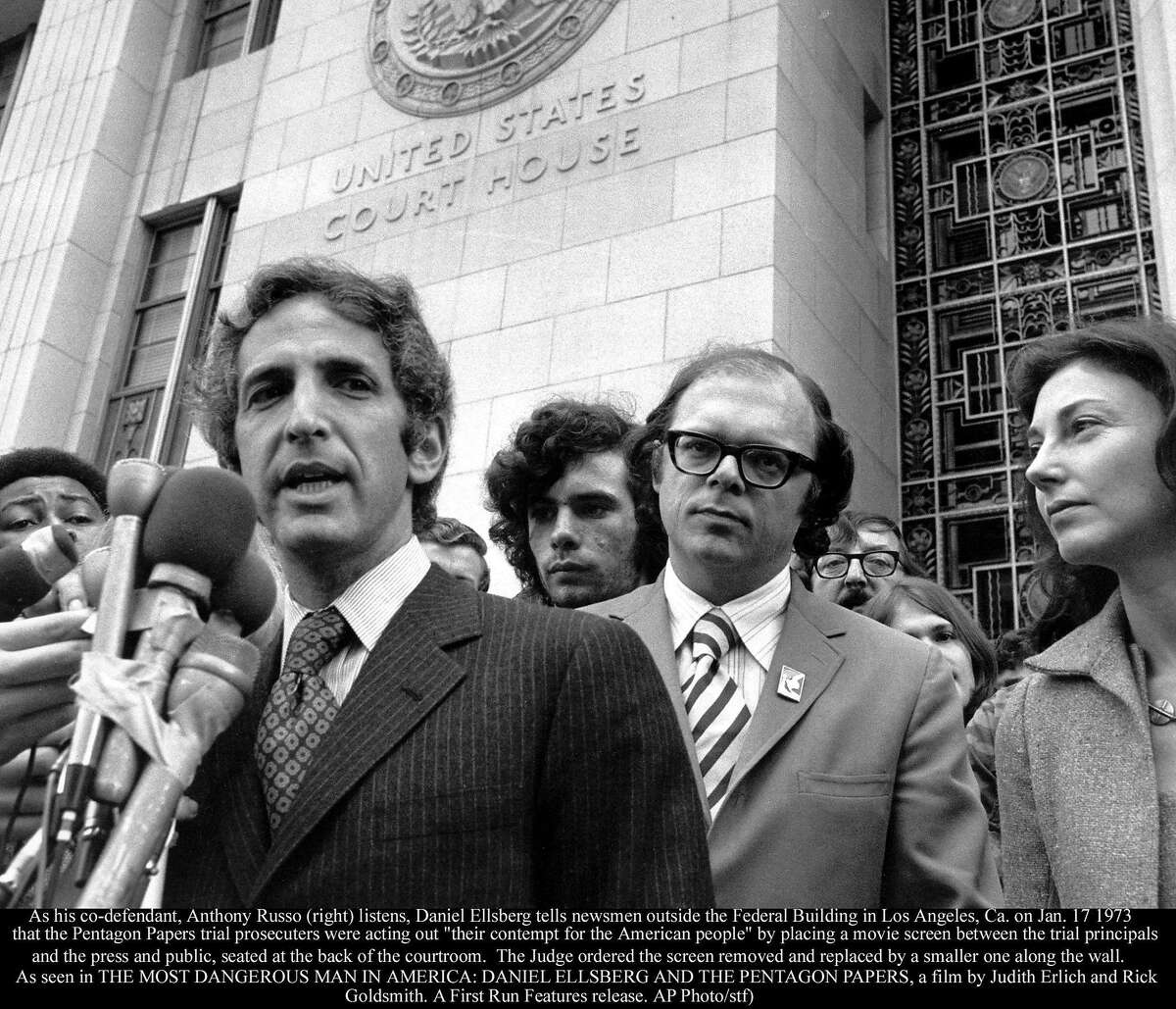 As his co-defendant, Anthony Russo (right) listens, Daniel Ellsberg tells newsmen outside the Federal Building in Los Angeles, Ca. on Jan. 17 1973 that the Pentagon Papers trial prosecutors were acting out "their contempt for the American people" by placing a movie screen between the trial principals and the press and public, seated at the back of the courtroom. The Judge ordered the screen removed and replaced by a smaller one along the wall. (AP Photo/stf) As seen in the Oscar-nominated documentary "THE MOST DANGEROUS MAN IN AMERICA: DANIEL ELLSBERG AND THE PENTAGON PAPERS"