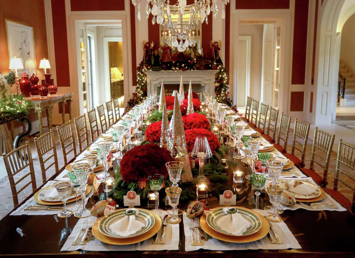 Sheridan and John Eddie Williams have lavish and lovely tablescapes for formal holiday dinners. Their centerpieces include fresh red roses, glass Christmas trees, greenery and lots of candles.
