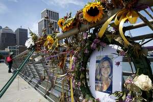 FILE - In this July 17, 2015 file photo, flowers and a portrait of Kate Steinle remain at a memorial site on Pier 14 in San Francisco. San Francisco jurors heard the muddled confession of the Mexican national on trial for the fatal shooting of Kate Steinle, whose death touched off a fierce debate over immigration. On Wednesday, Nov. 1, 2017, prosecutors played a portion of the interrogation of Jose Ines Garcia Zarate recorded several hours after Steinle was shot on July 1, 2015. (Paul Chinn /San Francisco Chronicle via AP, File)