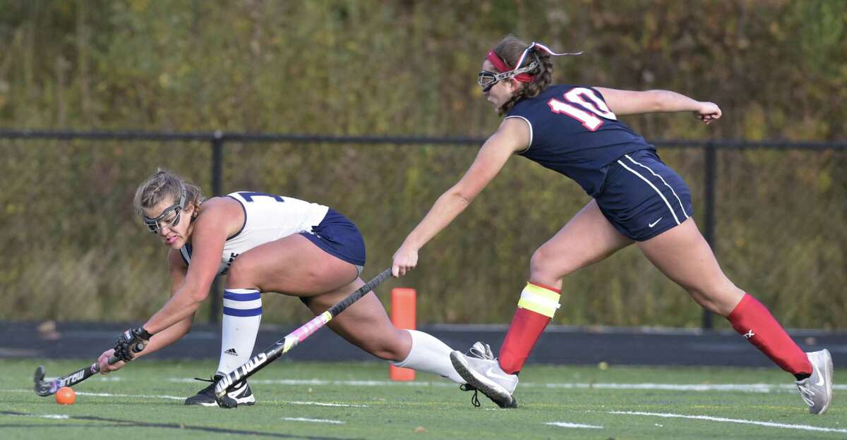 Immaculate's Madison Halas (14) takes a shot while being defended by New Fairfield's Dana Giardina (10) to score the games only goal in the girls State Class S Field Hockey playoff game between New Fairfield and Immaculate high schools, on Thursday afternoon, November 9, 2017, at Immaculate High School, in Danbury, Conn.