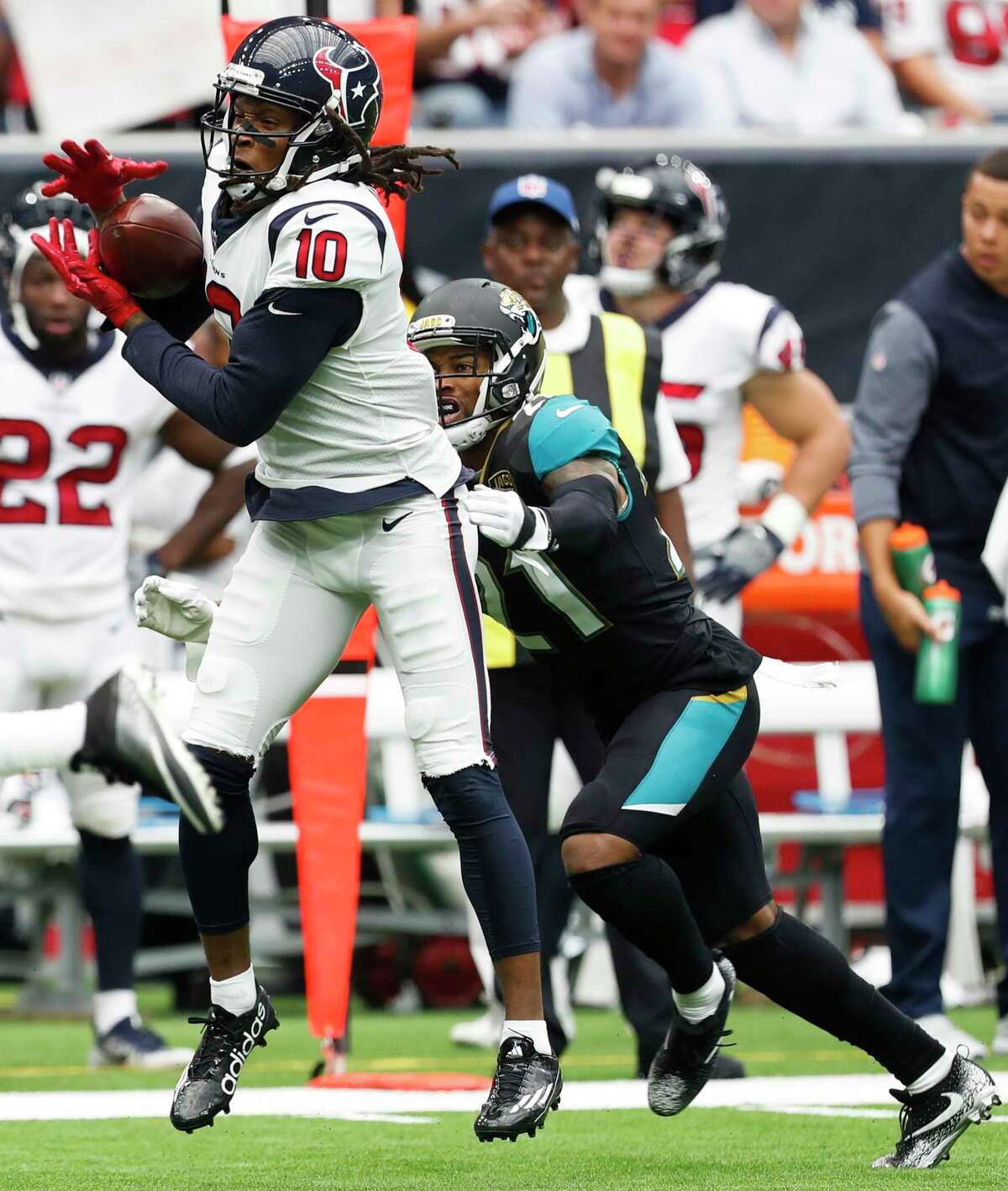 Texans receiver DeAndre Hopkins, left, makes a catch in front of Jaguars cornerback A.J. Bouye during Jacksonville's win in the season opener.