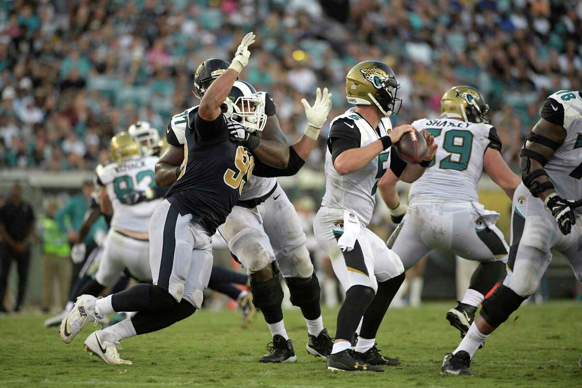 The Jaguars' Patrick Omameh has his hands full trying to keep the Rams' Aaron Donald, left, from sacking quarterback Blake Bortles in their Oct. 15 game.