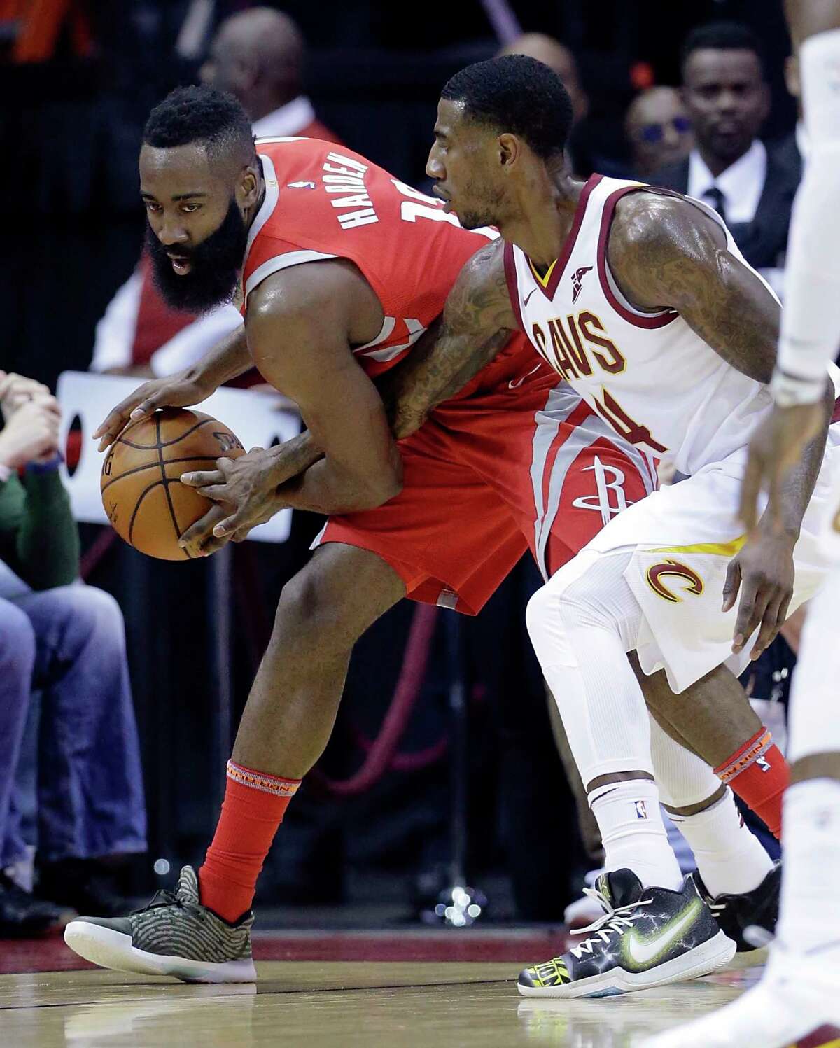 Houston Rockets guard James Harden (13) keeps the ball from the reach of Cleveland Cavaliers guard Iman Shumpert (4) during the first half of an NBA basketball game Thursday, Nov. 9, 2017, in Houston. (AP Photo/Michael Wyke)
