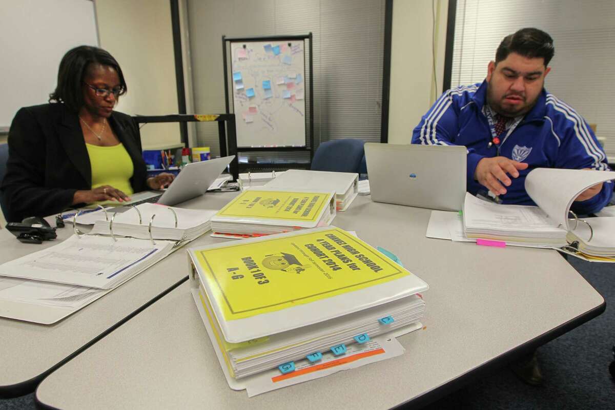 Chavez High School administrator Roel Saldivar works on the school's master schedule. Recently purchased software will automate scheduling at HISD's 38 high schools, a process that now takes weeks of work.