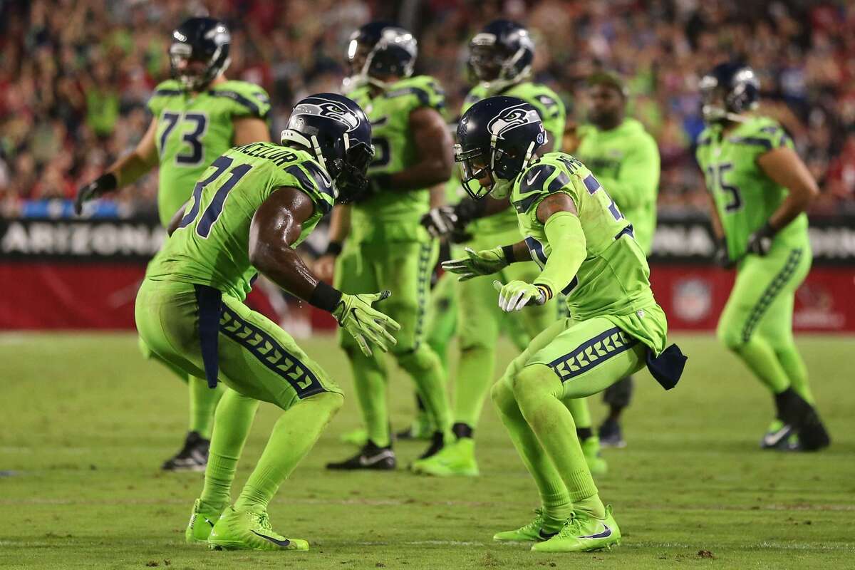 Strong safety Kam Chancellor #31 and defensive back Bradley McDougald #30 of the Seattle Seahawks celebrate a turnover on downs against the Arizona Cardinals at University of Phoenix Stadium on Nov. 9, 2017 in Glendale, Arizona. The Seattle Seahawks won 22-16.