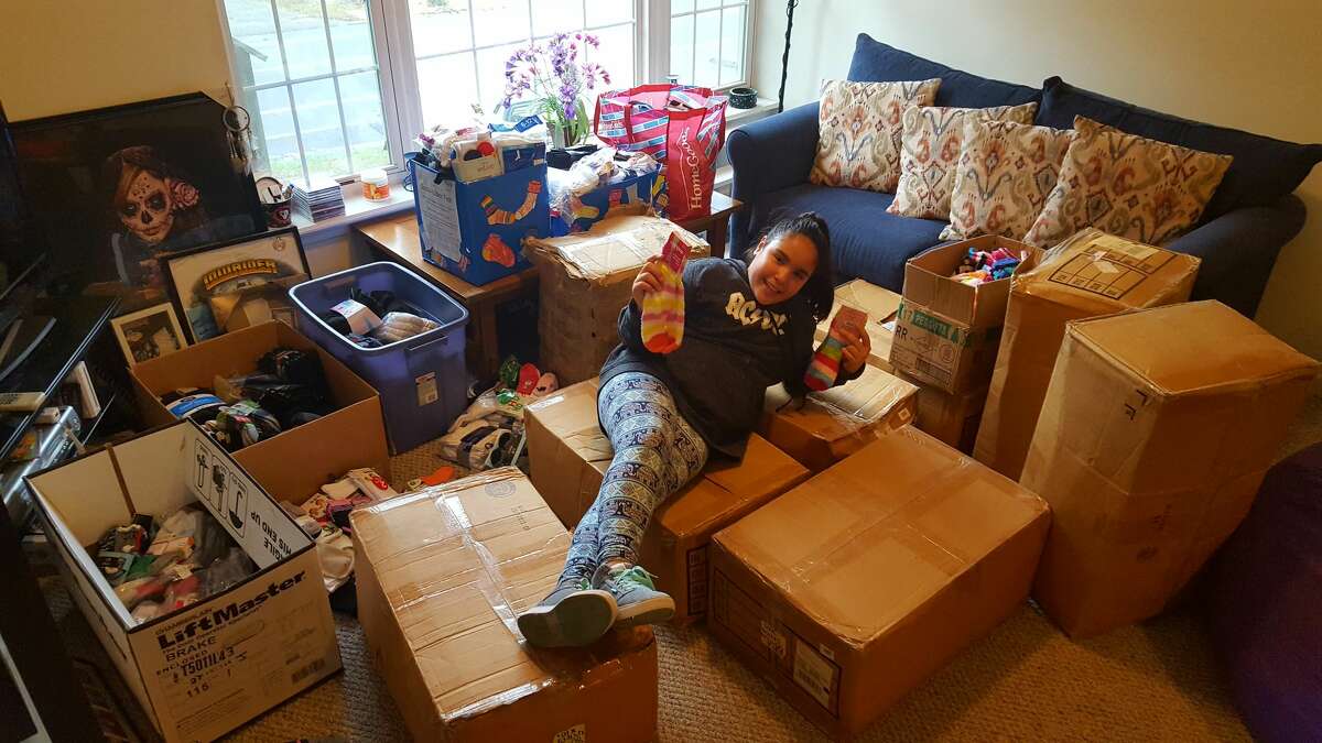 Eleven-year-old Seymour Middle School student Adelina "Lulu" Barreira collected 4,147 pairs of socks to donate to local charities through her project, "Lulu's Socktober Fest."