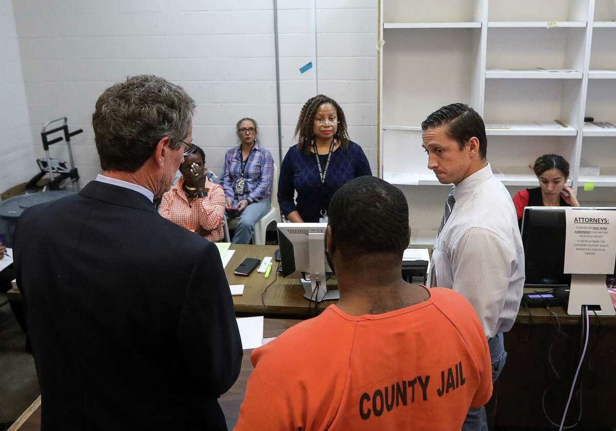 Judge Maria Jackson, center, Assistant District Attorney Joshua Phanco, front right, and defense attorney Randy Martin, left, listen as Martin's client asks for a jury trial.