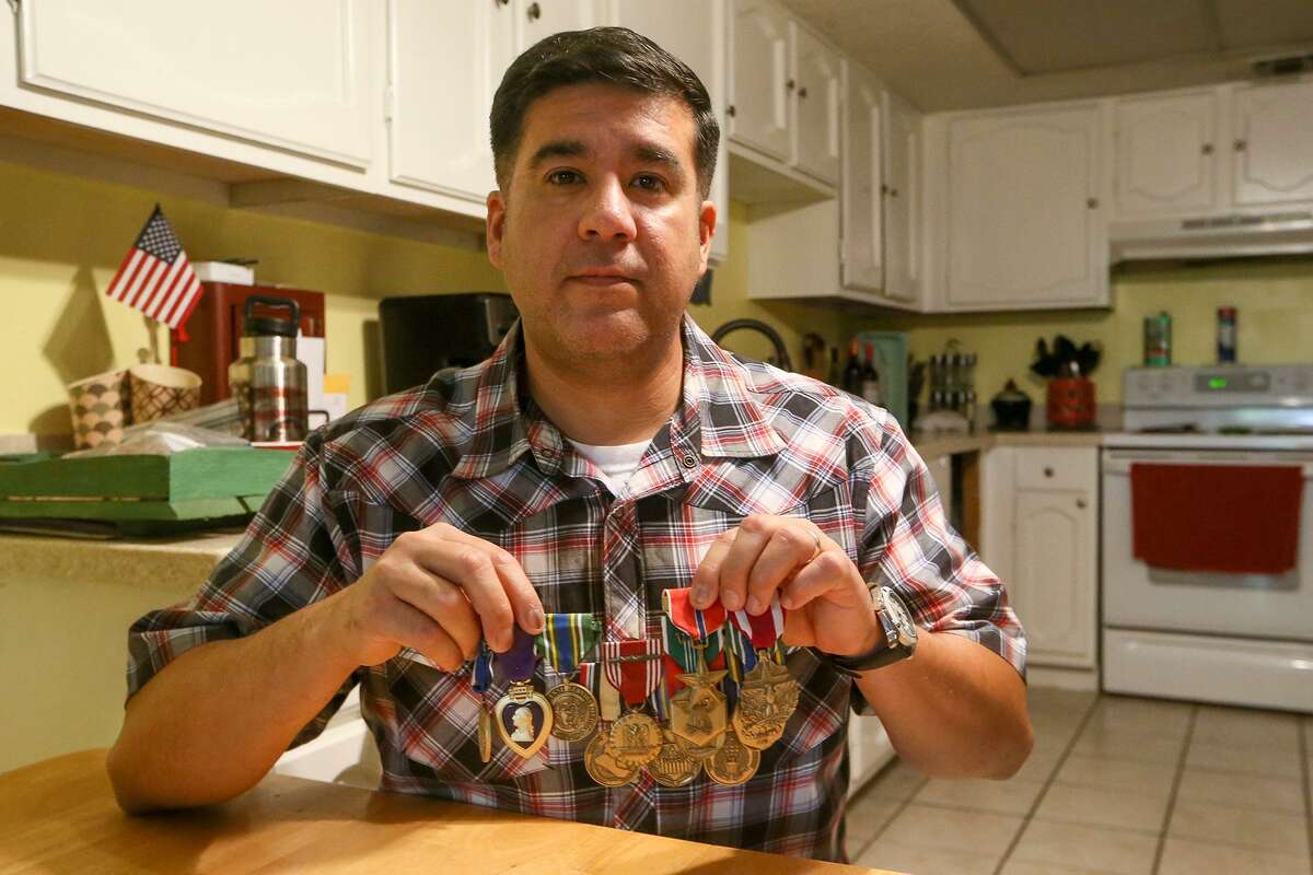 Army Sgt.1st Class Gabriel Monreal with medals he has received including a Purple Heart, two Bronze Stars and an Army Commendation Medal at his home. Monreal has served for twenty years including tours in both Iraq and Afghanistan.