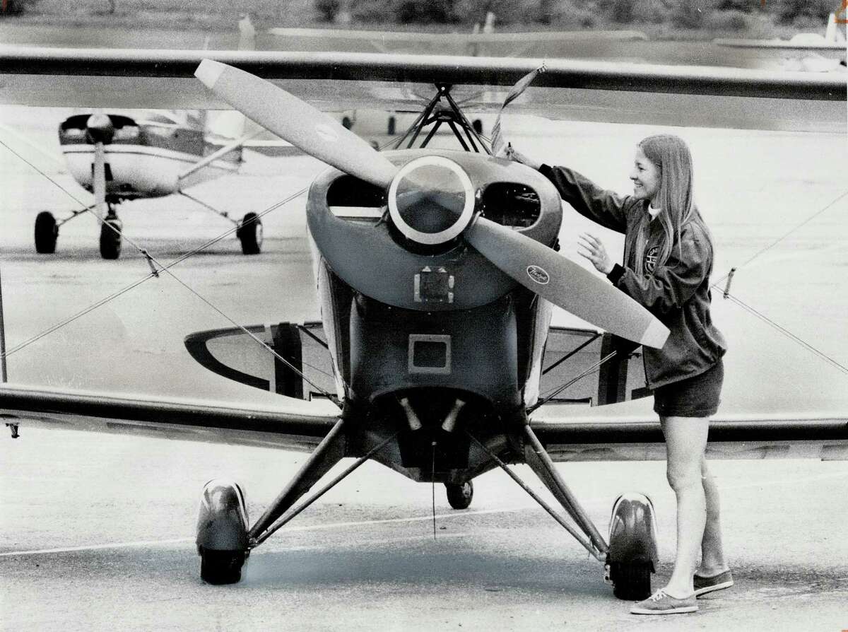 In this file photo from the 1970s, Debbie Gary does a pre-flight check of her stunt biplane.﻿