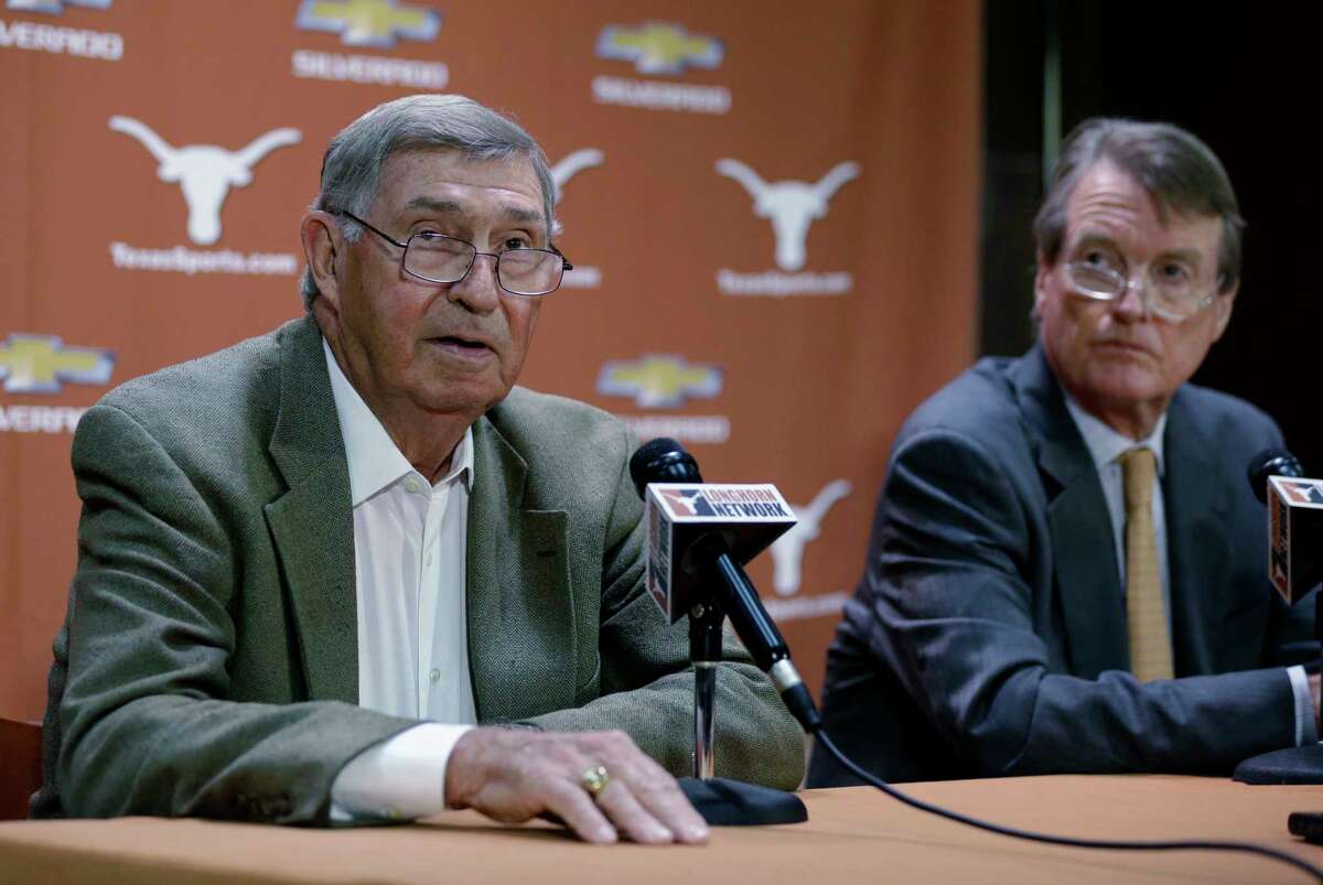 FILE - In this Oct. 1, 2013, file photo, Texas athletic director DeLoss Dodds, left, with Texas president Bill Powers, right, formally announces his retirement during a news conference, in Austin, Texas. Dodds, Powers and former football coach Mack Brown all are scheduled to be questioned under oath next week in a sex and race discrimination lawsuit filed by former women's track coach Bev Kearney, who was forced out after the school learned she had a romantic relationship with one of her athletes a decade earlier. (AP Photo/Eric Gay, File)