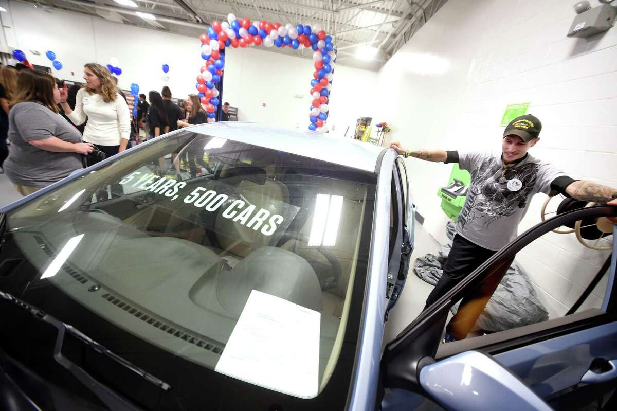 U.S. Army veteran Jacob Handy of Bristol looks over a 2014 Hyundai Accent he received at the Progressive Service Center in Milford during the company’s fifth annual Keys to Progress event Thursday. The car was restored by Breezy Point Auto Body of Stratford.