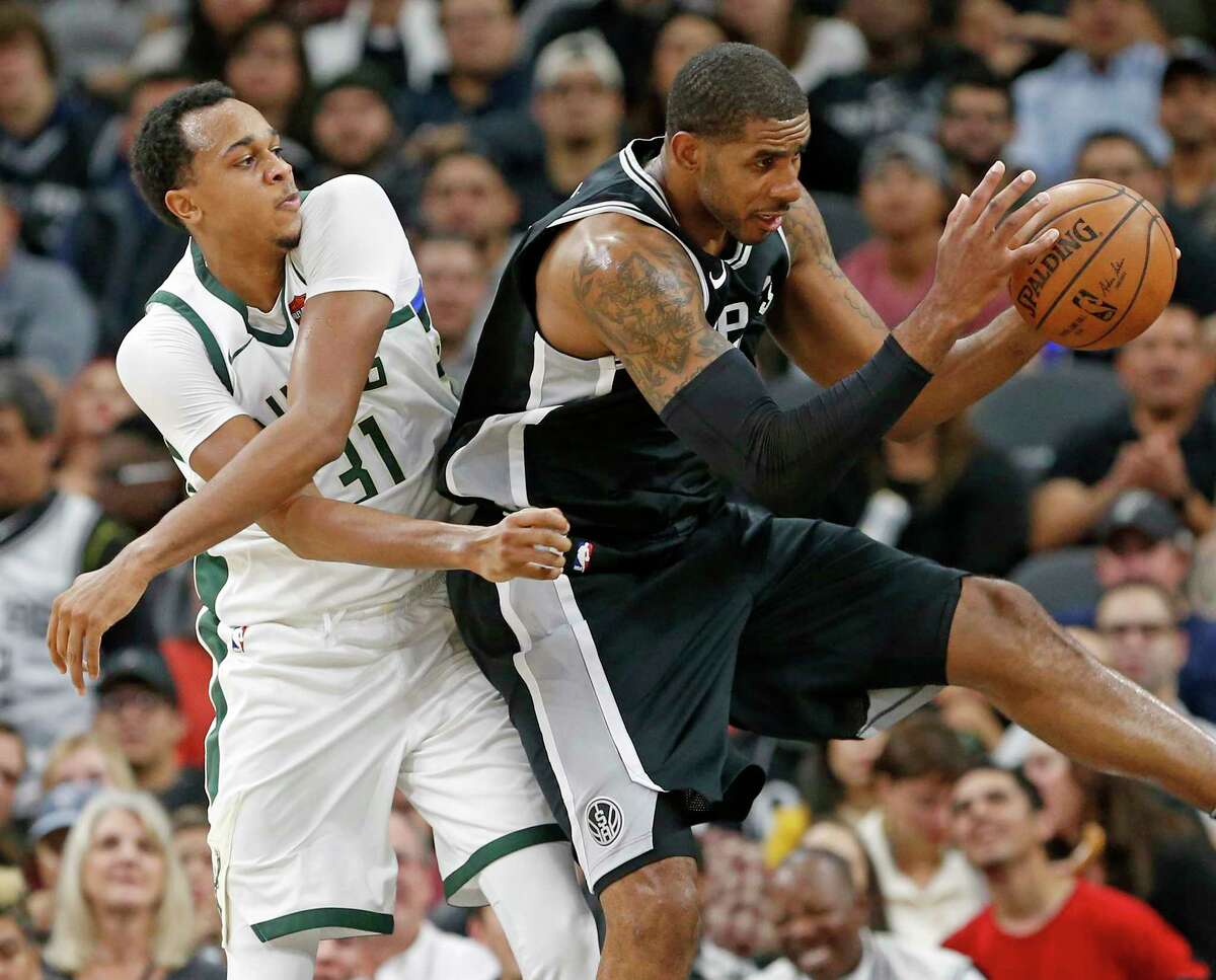 Milwaukee Bucks John Henson and San Antonio Spurs' LaMarcus Aldridge grab for a rebound during first half action Friday Nov. 10, 2017 at the AT&T Center.