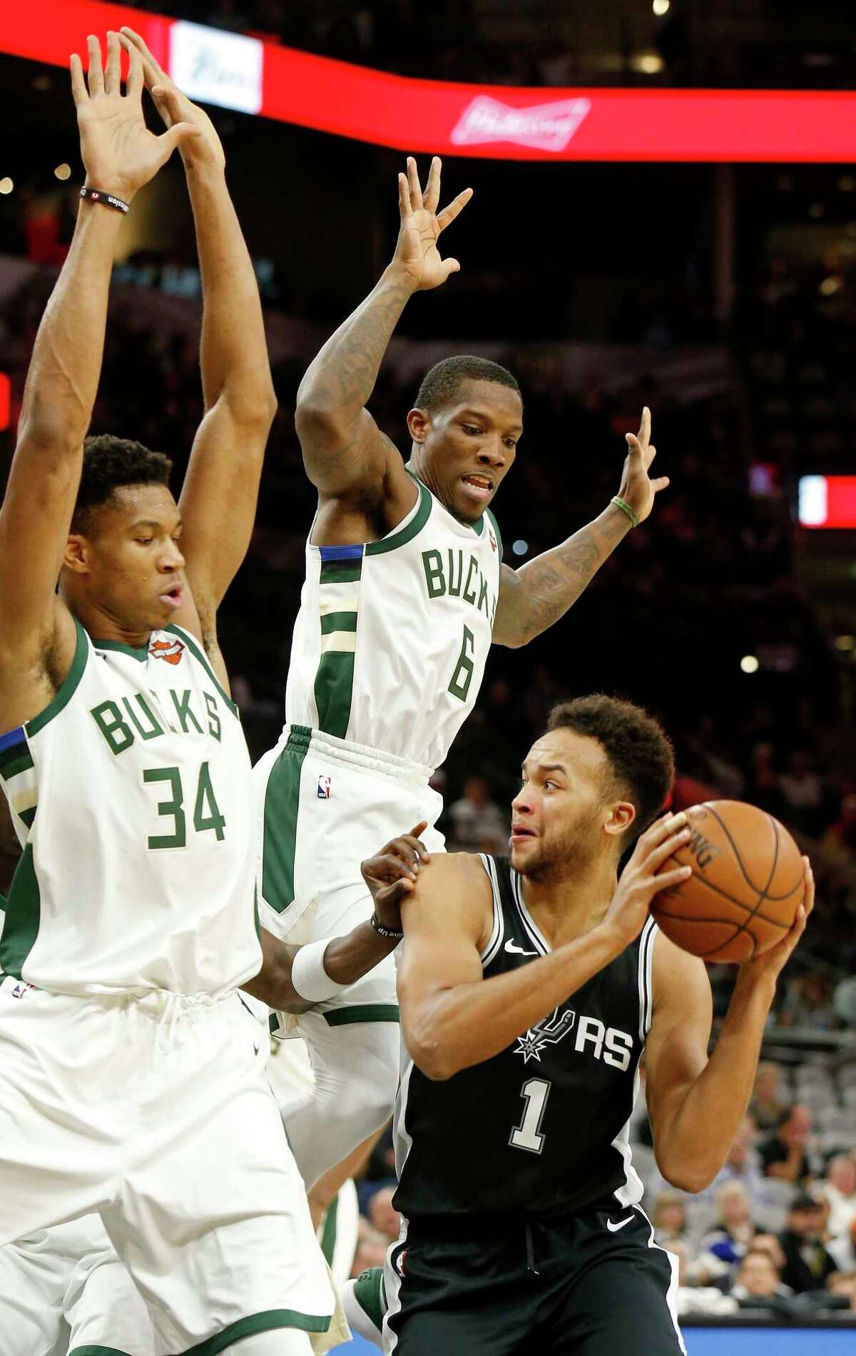 San Antonio Spurs Kyle Anderson looks for room around Milwaukee Bucks Giannis Antetokounmpo (left) and Eric Bledsoe during first half action Friday Nov. 10, 2017 at the AT&T Center.