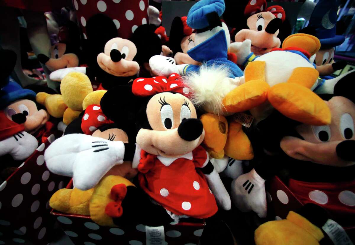 FILE - This Jan. 31, 2014, file photo shows plush Disney characters piled up in a display at a Disney Store in Saugus, Mass. The Walt Disney Co. reports financial results on Thursday, Nov. 9, 2017. (AP Photo/Elise Amendola, File)