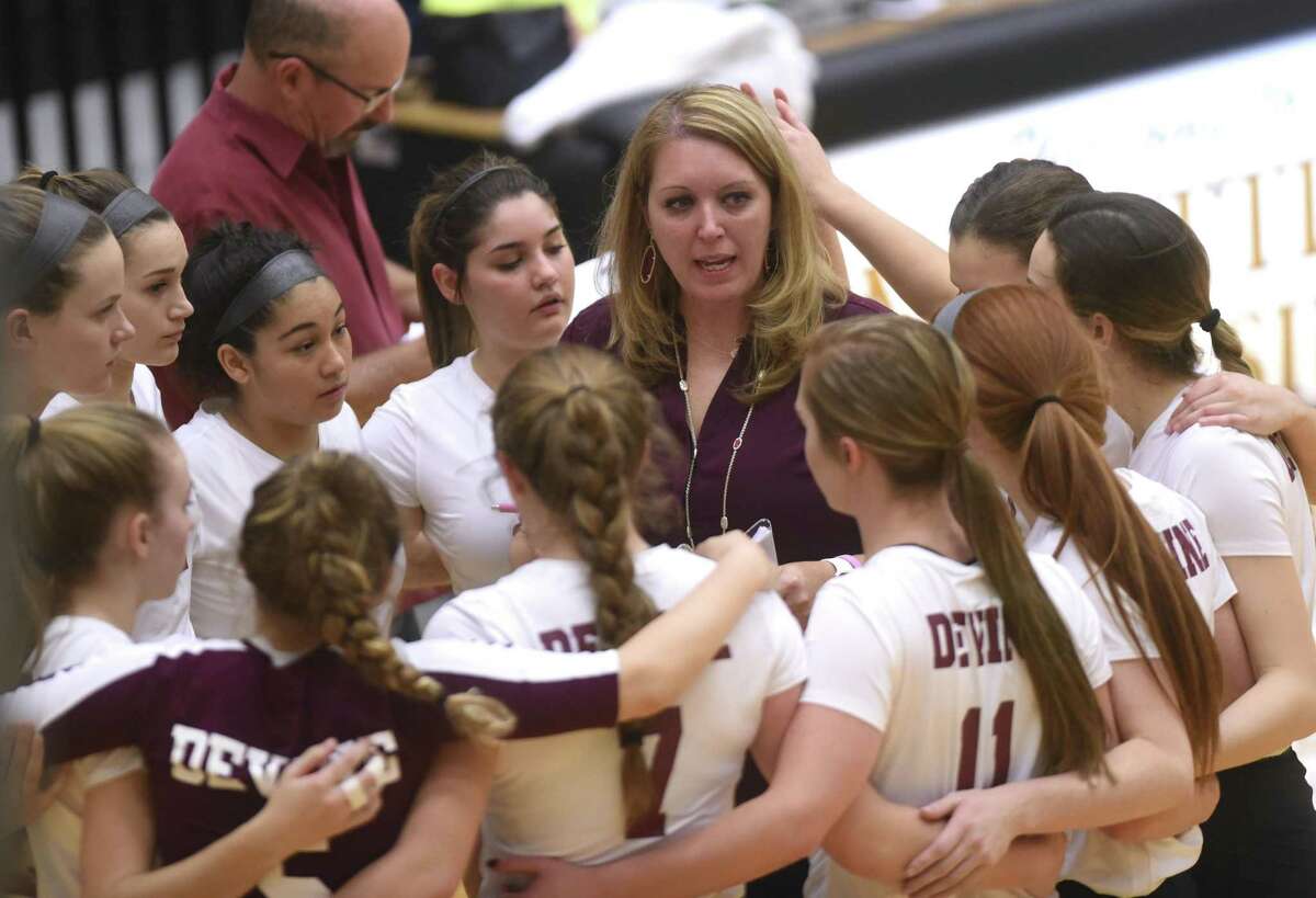 Devine volleyball coach Leigh Anne McIver speaks with her team during UIL Region IV-4A volleyball playoffs action against Needville at Littleton Gym on Friday, Nov. 10, 2017.